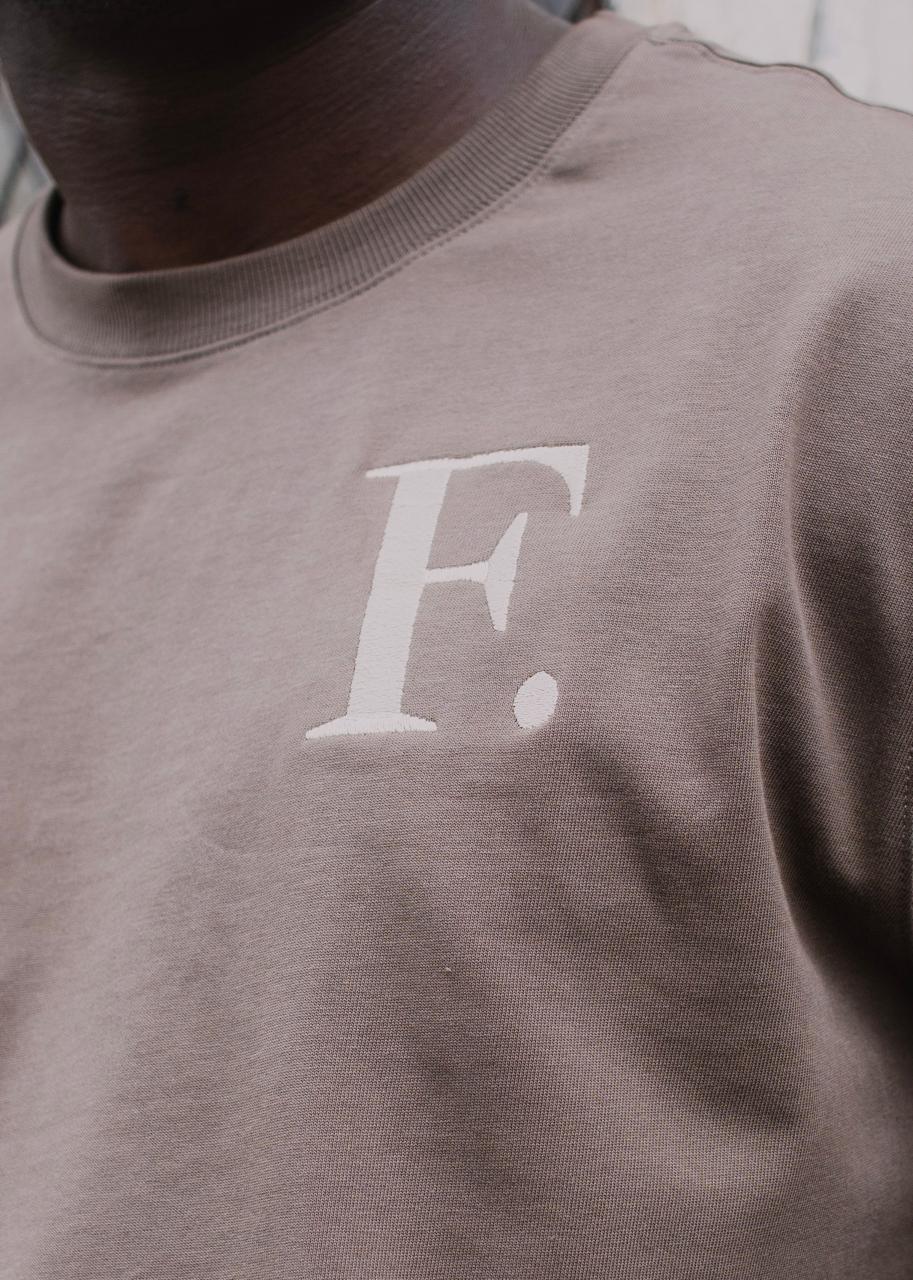 The F. mark embroidered on the chest